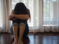 Sad and despaired woman hug her knee and cry while sitting alone