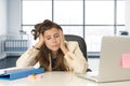 Sad and desperate businesswoman suffering stress and headache at office laptop computer desk Royalty Free Stock Photo