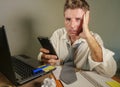 Sad desperate man in lose necktie messy and depressed working at laptop computer in business office problem and stress concept ho Royalty Free Stock Photo