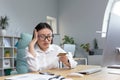 sad and disappointed asian woman trying to make a purchase in online store, business woman using phone and bank credit Royalty Free Stock Photo