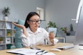 sad and disappointed asian woman trying to make a purchase in online store, business woman using phone and bank credit Royalty Free Stock Photo