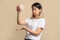 Sad and disappointed beautiful Asian woman holding a piggy bank with no money left Royalty Free Stock Photo