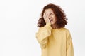 Sad and disappointed redhead woman facepalm, looking upset, disstressed by bad upsetting news, standing frustrated