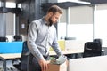 Sad dismissed worker are taking his office supplies with him from office Royalty Free Stock Photo