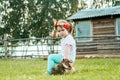 Sad displeased and angry child, girl sitting on a fence in the village. walks in the countryside. farming Royalty Free Stock Photo