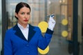 Sad displeased stewardess who holds a new model of an airplane in white gloves at the airport. airline flight operations concept