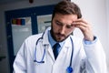 Sad doctor standing in corridor Royalty Free Stock Photo