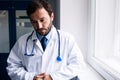 Sad doctor standing in corridor Royalty Free Stock Photo