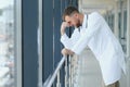 Sad doctor standing in hospital corridor Royalty Free Stock Photo