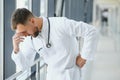 Sad doctor standing in hospital corridor Royalty Free Stock Photo