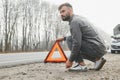 Sad driver having engine problem standing near broken car on the road. Car breakdown concept Royalty Free Stock Photo