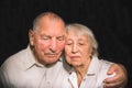 Sad elderly couple on a black background Royalty Free Stock Photo