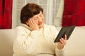 Sad elderly woman looking at photo frame Royalty Free Stock Photo