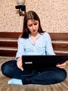 Sad european woman sit on bed and use laptop Royalty Free Stock Photo