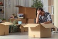 Sad evicted man moving home complaining on the floor