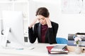 Sad exhausted businesswoman having headache and touching head Royalty Free Stock Photo