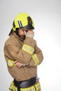 Sad, exhausted firefighter tiredly rubbing forehead in studio. Royalty Free Stock Photo