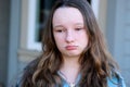 sad face of a beautiful girl crying under puffy eyes light allergy freckles on the street close face upset teenage girl Royalty Free Stock Photo