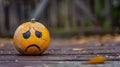 Sad Face Drawn on Yellow Ball