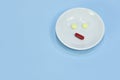 Sad face made of medicine. pain medication tablets. Assorted pharmaceutical pills, tablets and capsules over blue background Royalty Free Stock Photo