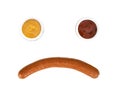 Sad face from mustard with ketchup and sousage