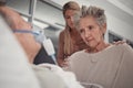 Sad family, old woman and man in bed at hospital with ventilator for breathing, healthcare or support. Senior wife