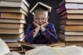 A sad fat boy with glasses sits with books at the table. Black background. Education and knowledge. Close-up Royalty Free Stock Photo