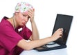 Sad female doctor checking laptop Royalty Free Stock Photo