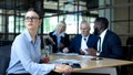 Sad female manager looking window during office meeting, workload tiredness