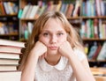 Sad female student in library looking at camera Royalty Free Stock Photo