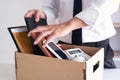 Sad Fired Young Employee businessmen hold boxes including pot plant and documents for personal belongings unemployment, resigned