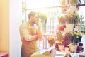 Sad florist man or seller at flower shop counter Royalty Free Stock Photo