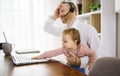 sad and frustrated father in kitchen home office with computer and her daugher