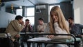 Sad frustrated insecure girl student sitting in classroom at desk suffering from abuse bad attitude ridicule from