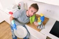 Sad and frustrated man washing the dishes and making home kitchen sink clean feeling tired Royalty Free Stock Photo