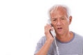 sad, frustrated, negative senior old man talking via home telephone Royalty Free Stock Photo