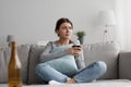 Sad frustrated tired caucasian pretty millennial woman with glass of wine suffering from depression, loneliness Royalty Free Stock Photo