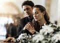 Sad, funeral and flowers with couple and coffin in church for death, respect and mourning. Grief, goodbye and empathy Royalty Free Stock Photo