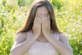 Sad girl covers face with her hands and weeps Royalty Free Stock Photo