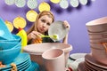 Sad girl feds up cleaning and washing in the kitchen with blue wall Royalty Free Stock Photo