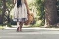 Sad girl feeling alone in the park. Lonely concepts. Beautiful toddler girl and fluffy stay alone under the big tree Royalty Free Stock Photo