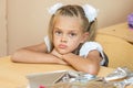 A sad girl at her desk at lesson of the first of September Royalty Free Stock Photo