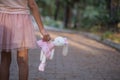 Sad girl hugging teddy bear sadness alone in green garden park. Lonely girl feeling sad unhappy walking outdoors with