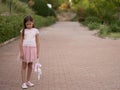 Sad girl hugging teddy bear sadness alone in green garden park. Lonely girl feeling sad unhappy walking outdoors with Royalty Free Stock Photo