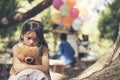 Sad girl hugging teddy bear sadness alone in green garden park. Lonely girl feeling sad unhappy sitting outdoors with best friend Royalty Free Stock Photo