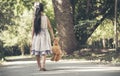 Sad girl hugging teddy bear sadness alone in green garden park. Lonely girl feeling sad unhappy walking outdoors with best friend Royalty Free Stock Photo