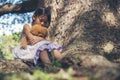 Sad girl hugging teddy bear sitting under tree sadness alone in green park. Lonely girl feeling sad unhappy sit outdoors hug best Royalty Free Stock Photo