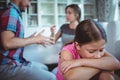 Sad girl listening to her parents arguing Royalty Free Stock Photo