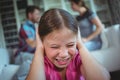 Sad girl listening to her parents arguing Royalty Free Stock Photo