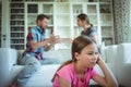 Sad girl listening to her parents arguing Royalty Free Stock Photo